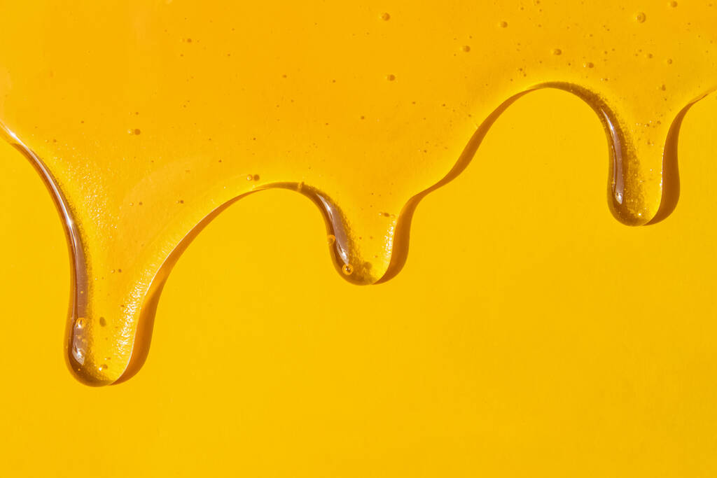 Flusso di miele dolce sullo sfondo giallo
 - Foto, immagini