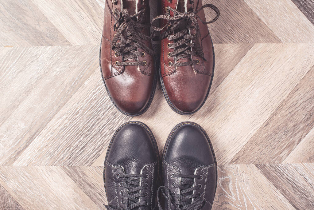 Black and brown colors of shoes on wooden background. Sale and shopping concept. Copy space. Banner. Classic winter warm fashion male shoes. - Photo, Image