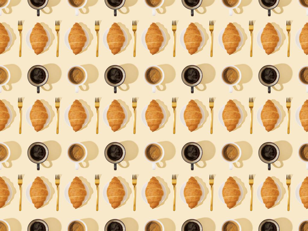 top view of golden forks, croissants and coffee on beige, seamless background pattern - Photo, Image