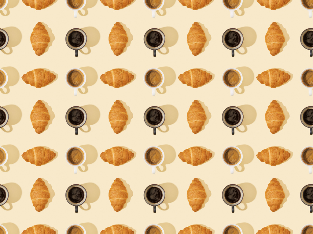 top view of croissants and coffee on beige, seamless background pattern - Photo, Image