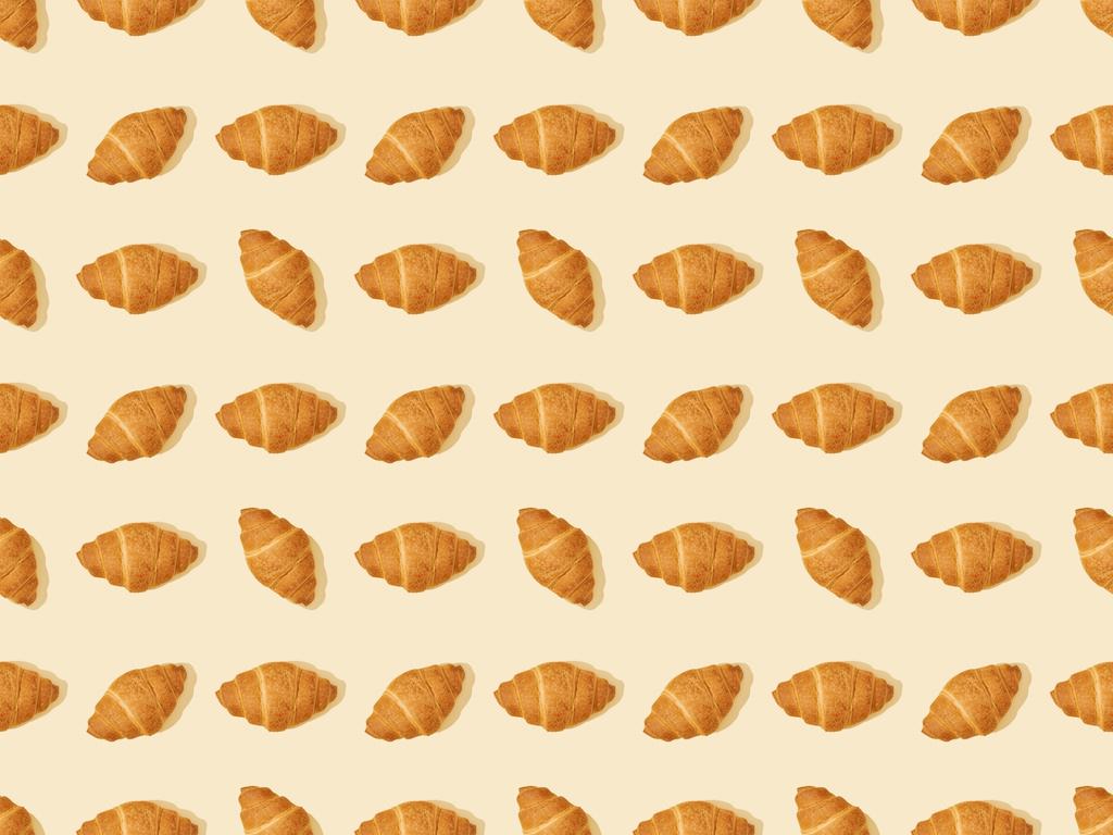top view of fresh croissants on beige, seamless background pattern - Photo, Image