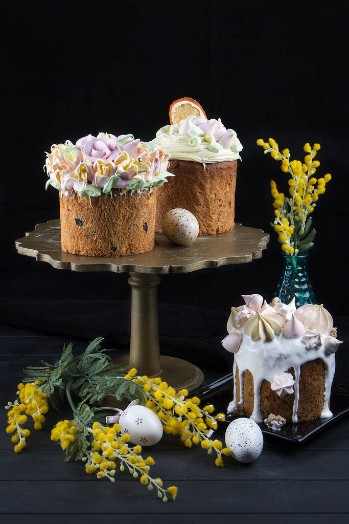 Various Spring Easter cakes with white icing and sugar decor on the table decorated in rustic style - Photo, Image