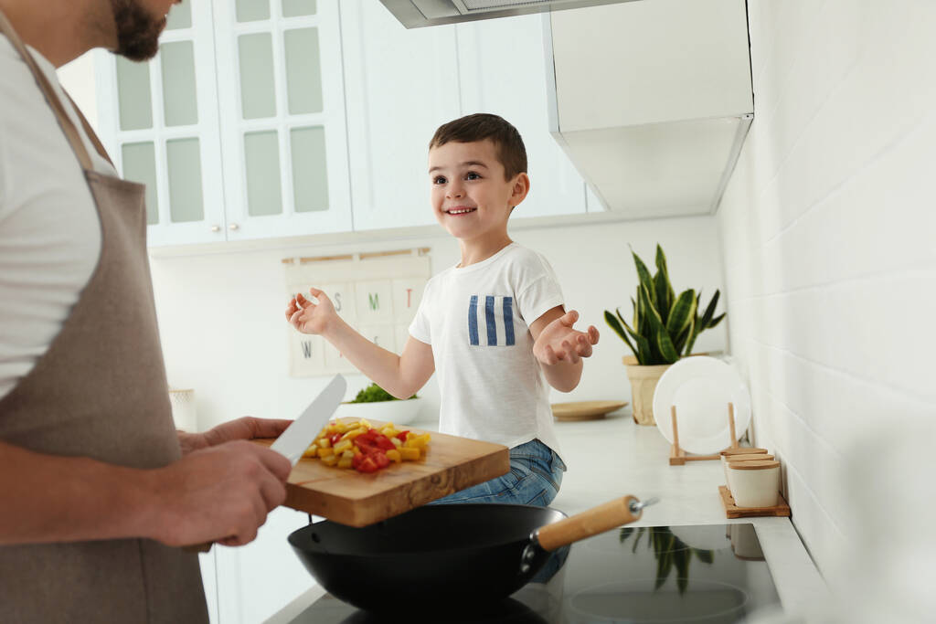 Isä ja poika kokkaavat yhdessä keittiössä, lähikuva
 - Valokuva, kuva