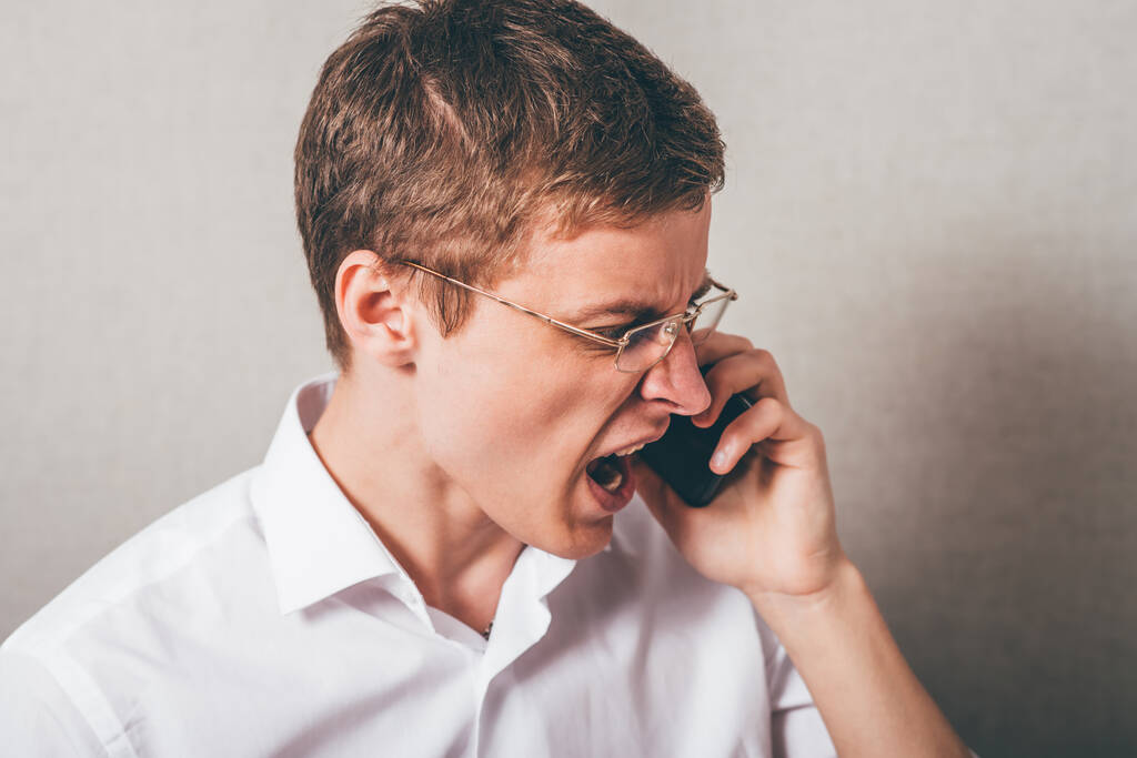 An angry businessman over the phone. - Photo, Image