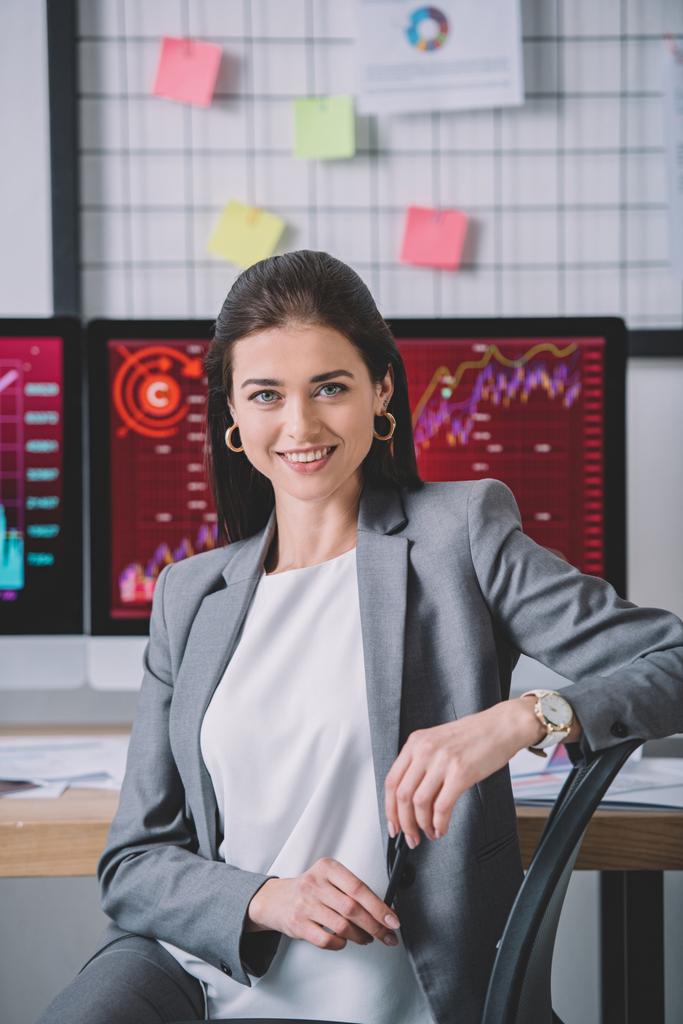 Beautiful data analyst smiling at camera with working in office  - Photo, Image