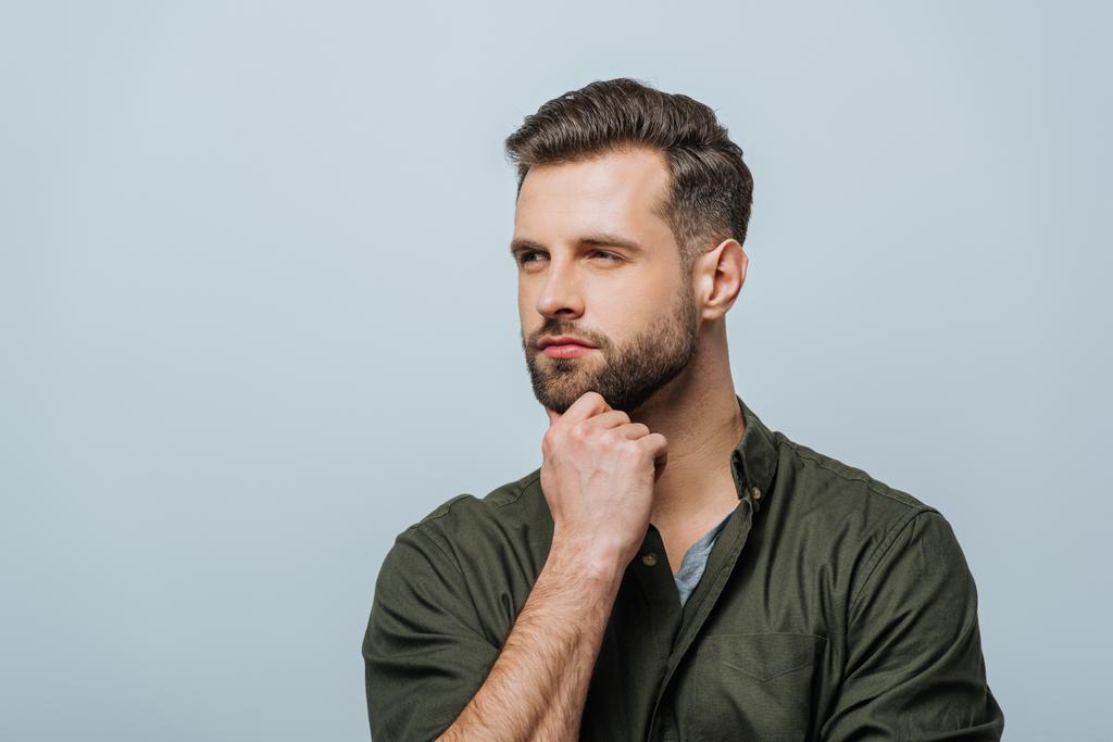 Confident man with hand near chin looking away isolated on grey - Photo, Image