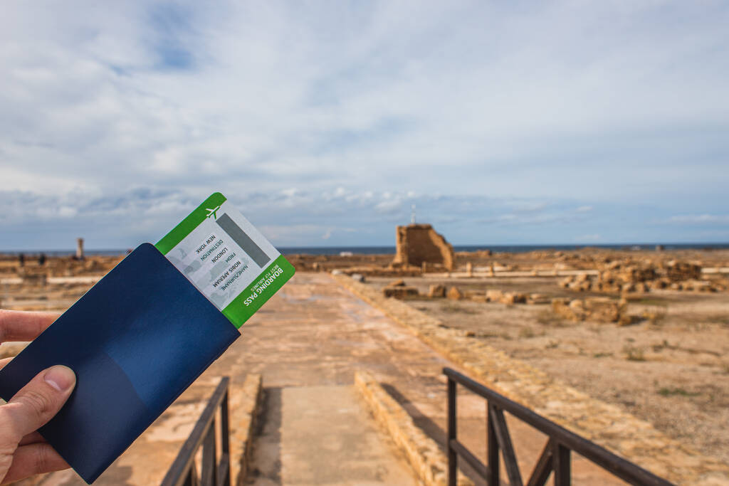 cropped view of man holding passport and boarding pass near ancient House of Theseus - Photo, Image