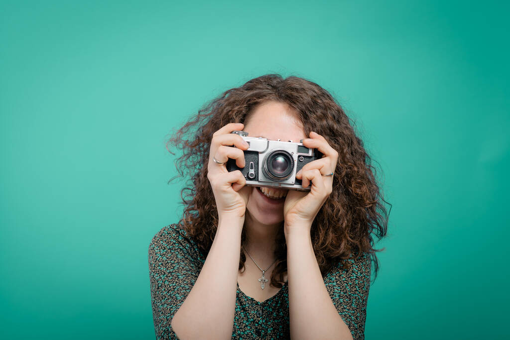 Woman with camera against studio background - Photo, Image