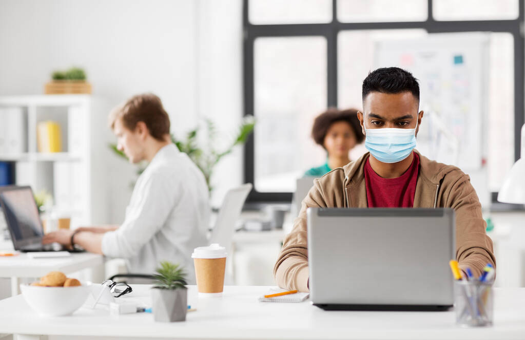 indian man with laptop in medical mask at office - Photo, Image