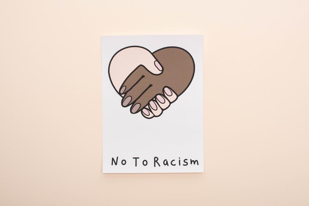 top view of picture with multiethnic handshake and no to racism lettering on beige background - Photo, Image