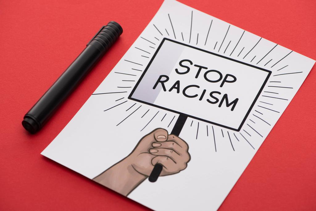 black marker and picture with drawn hand and stop racism placard on red background - Photo, Image