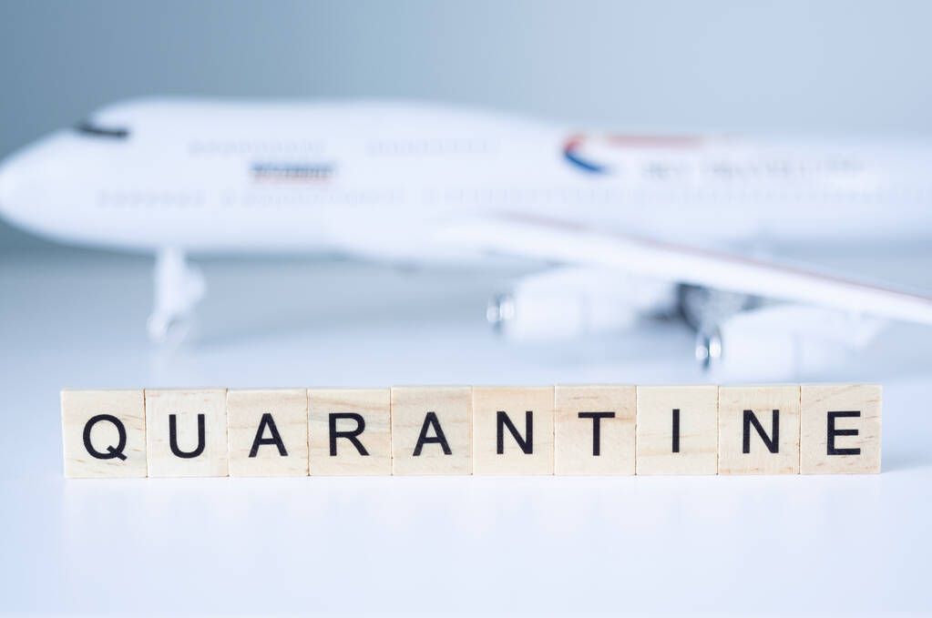 Word Quarantine against a toy plane on gray background. Concept of isolation. - Photo, Image