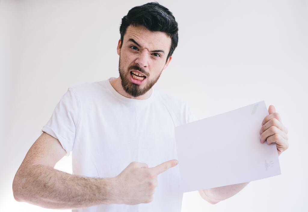 Bearded man holding a blank white sheet of paper - Photo, Image