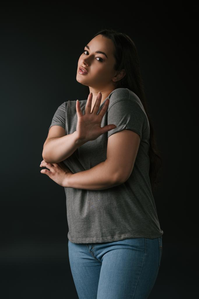 Confused plus size with stop gesture on black background - Photo, Image