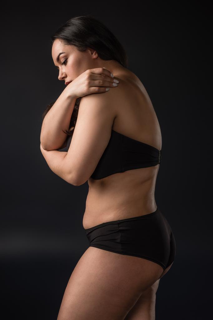 Side view of plus size girl in underware on black background - Photo, Image