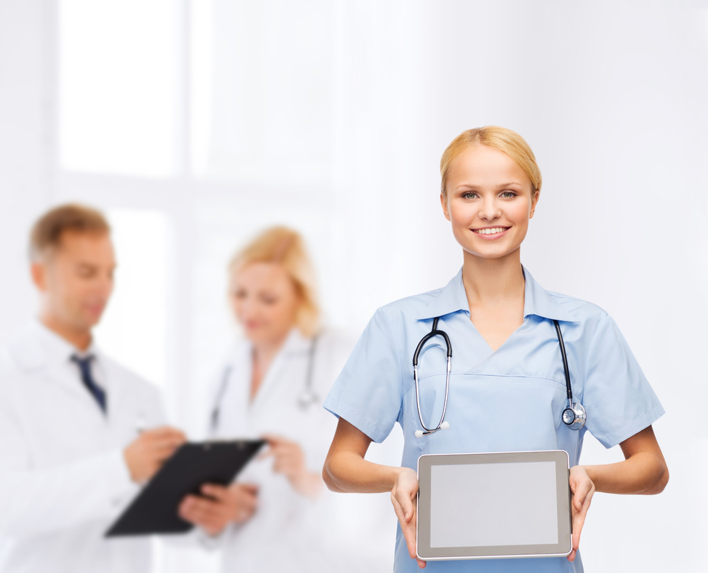 Hymyilevä naislääkäri tai sairaanhoitaja tabletin kanssa pc
 - Valokuva, kuva