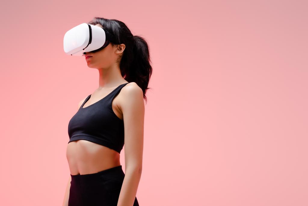 donna afroamericana in abbigliamento sportivo e auricolare realtà virtuale su rosa
  - Foto, immagini