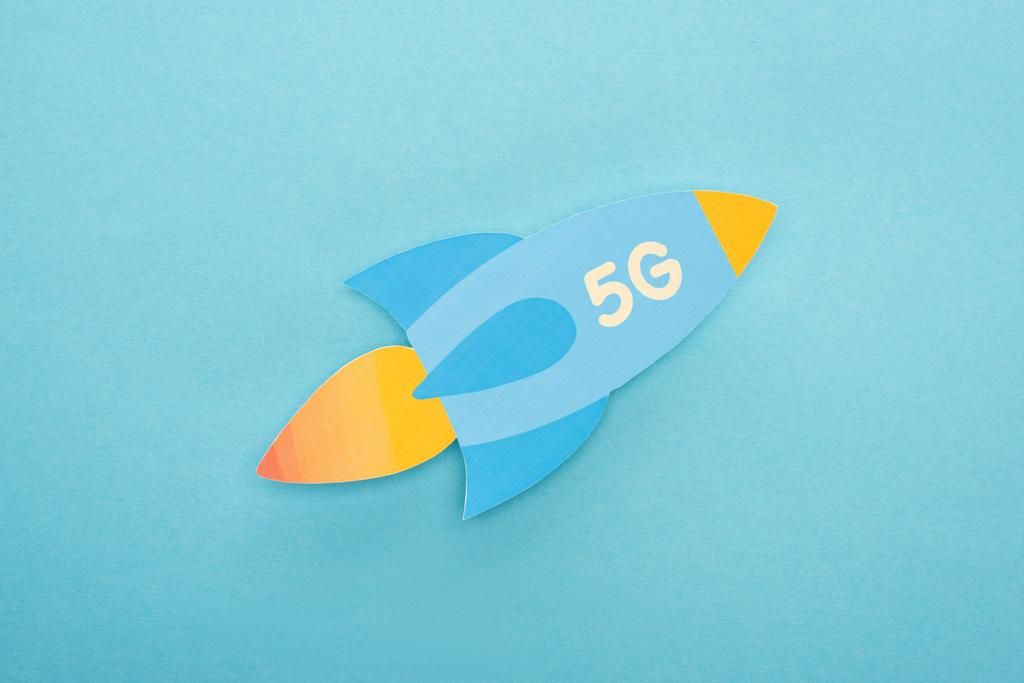 top view of paper rocket with 5g lettering on blue background - Photo, Image