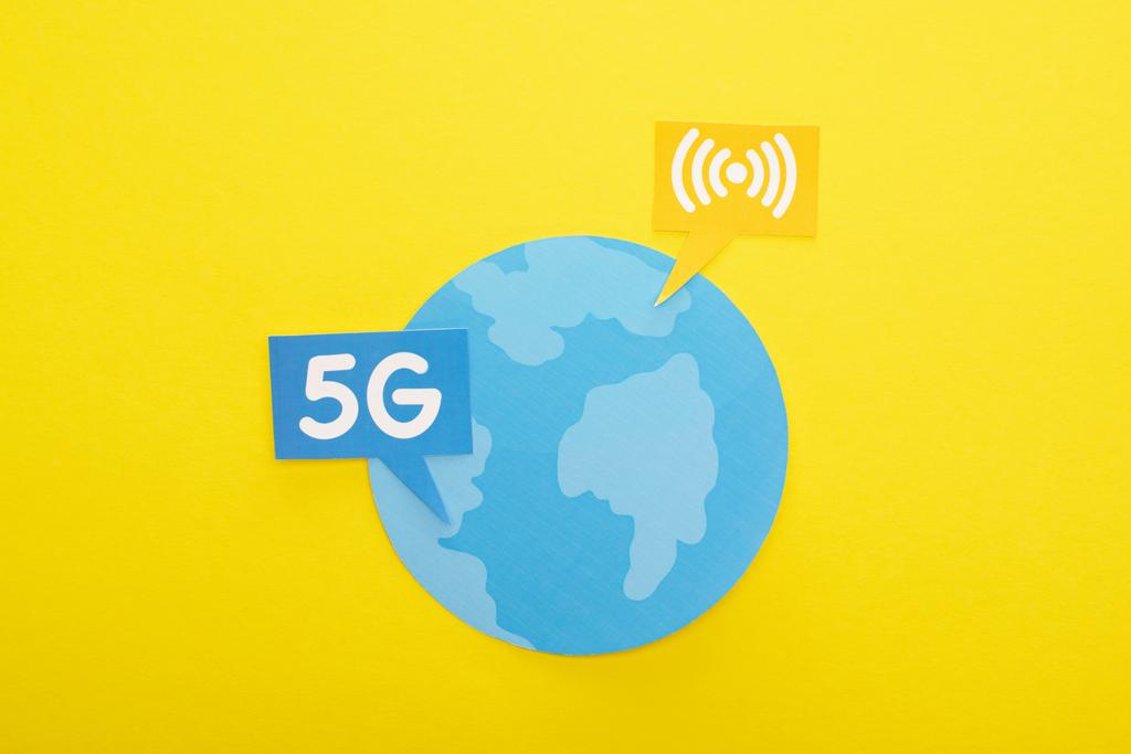 top view of globe and 5g lettering on yellow background - Photo, Image