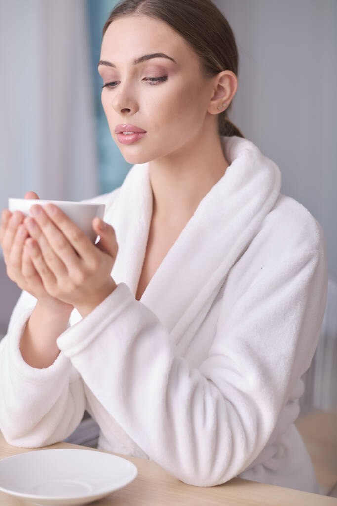 woman resting in a bathrobe at home - Photo, Image