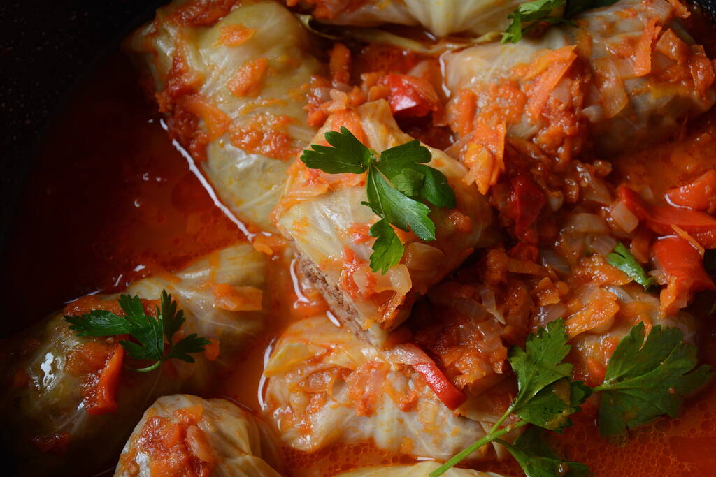 Cabbage rolls stuffed with ground beef and rice in tomato sauce - Photo, Image
