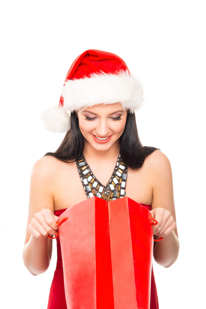 Счастливая женщина в рождественской шляпе с красной сумкой для покупок
 - Фото, изображение