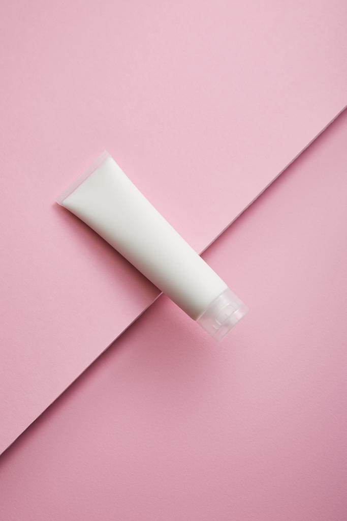 Top view of cosmetic cream tube on pink background - Photo, Image