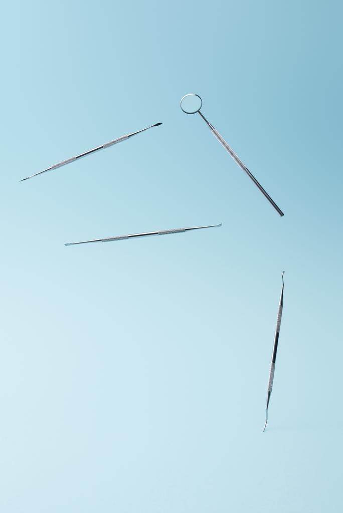 Dental examination instruments tools levitating on blue background - Photo, Image