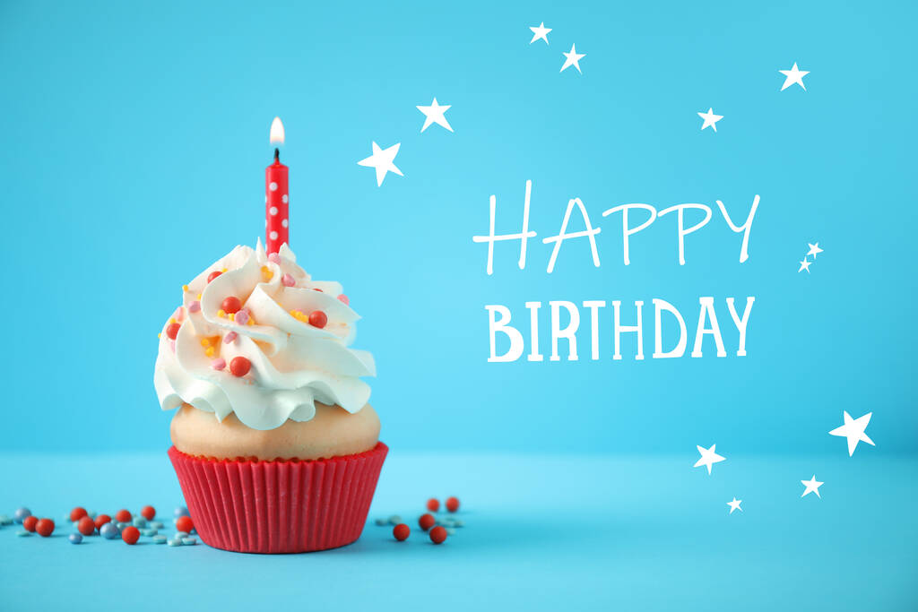 Text Happy Birthday and delicious cupcake with candle on light blue background - Photo, Image