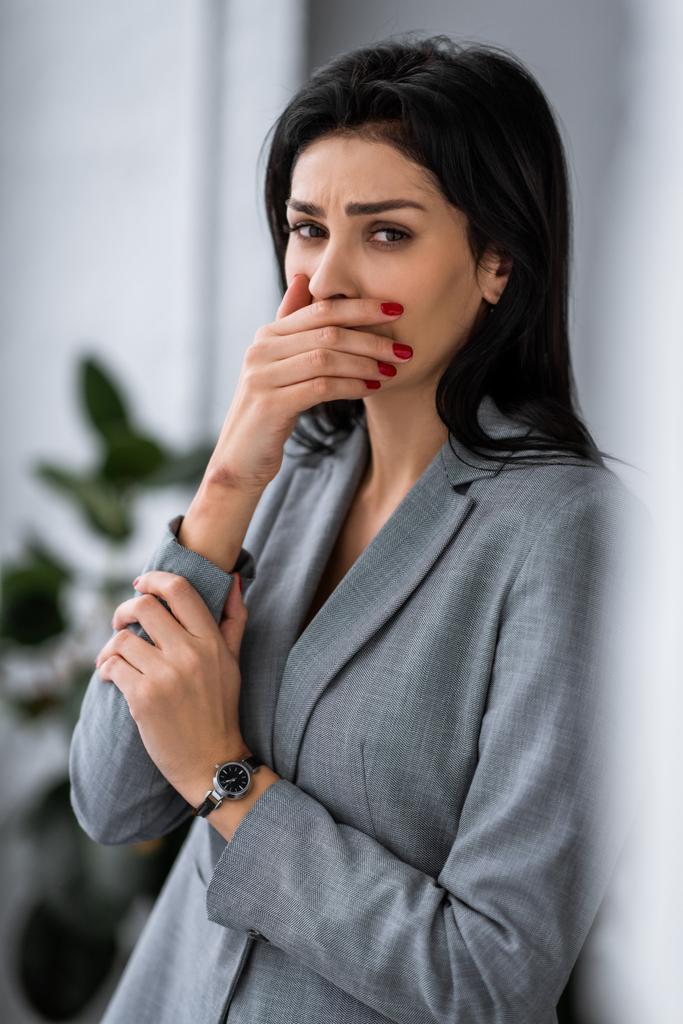 rozrušená podnikatelka s modřinami na rukou zakrývající ústa, domácí násilí koncept  - Fotografie, Obrázek