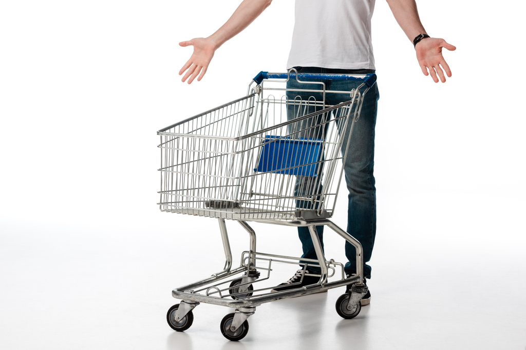 cropped view of man gesturing while standing near empty shopping cart on white  - Photo, Image