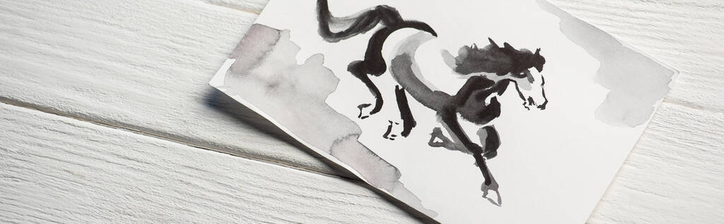 Top view of paper with japanese painting with horse on wooden background, panoramic shot - Photo, Image