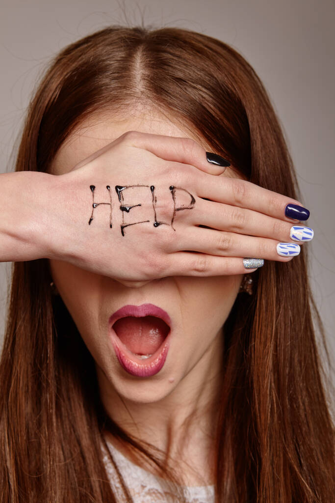 Segíts! A nők pszichológiai portréja segítségért kiált festett felirattal a kezén. Félelem, fájdalom, depresszió fogalma. - Fotó, kép