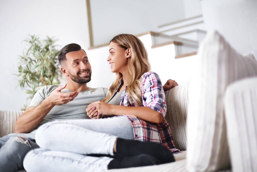 loving couple relaxing on the couch on a free evening - Photo, Image