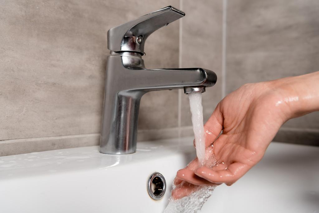 vista ritagliata della donna lavarsi la mano in bagno
  - Foto, immagini
