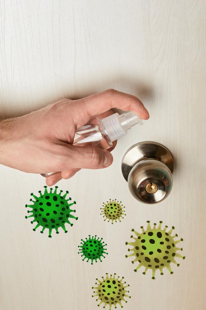 vue recadrée de l'homme désinfectant poignée de porte avec antiseptique, illustration de bactéries
 - Photo, image
