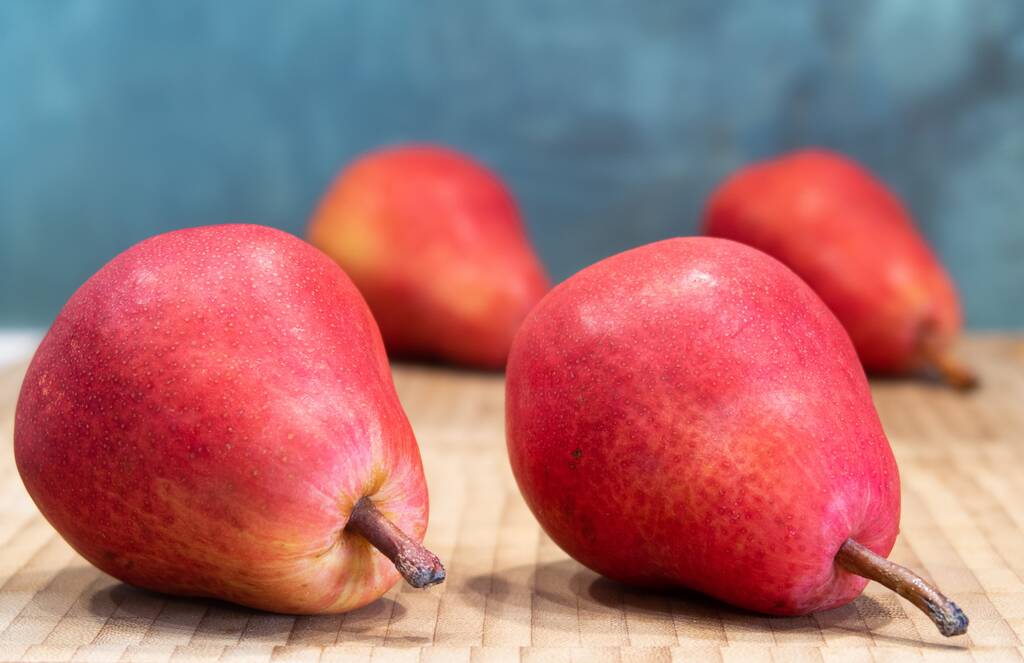 Four red pears, two against the background of the other two - Photo, Image