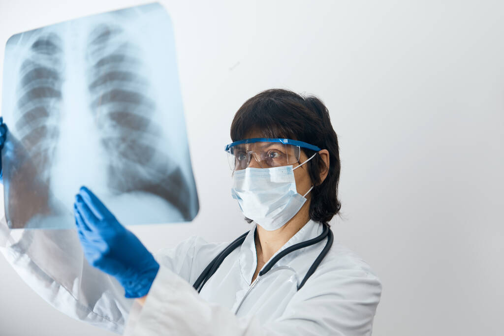 Lekarz-naukowiec badający infekcję wirusową lub zapalenie płuc na zdjęciu rentgenowskim klatki piersiowej. Koronawirus 2019, COVID-19 - Zdjęcie, obraz