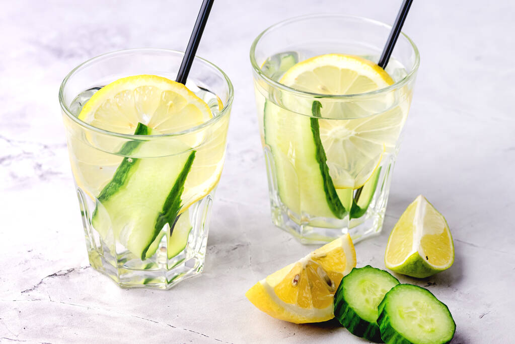 Gläser gesundes Detox-Wasser mit Zitrone und Gurken Diät-Trinkhalm waagerecht darüber - Foto, Bild