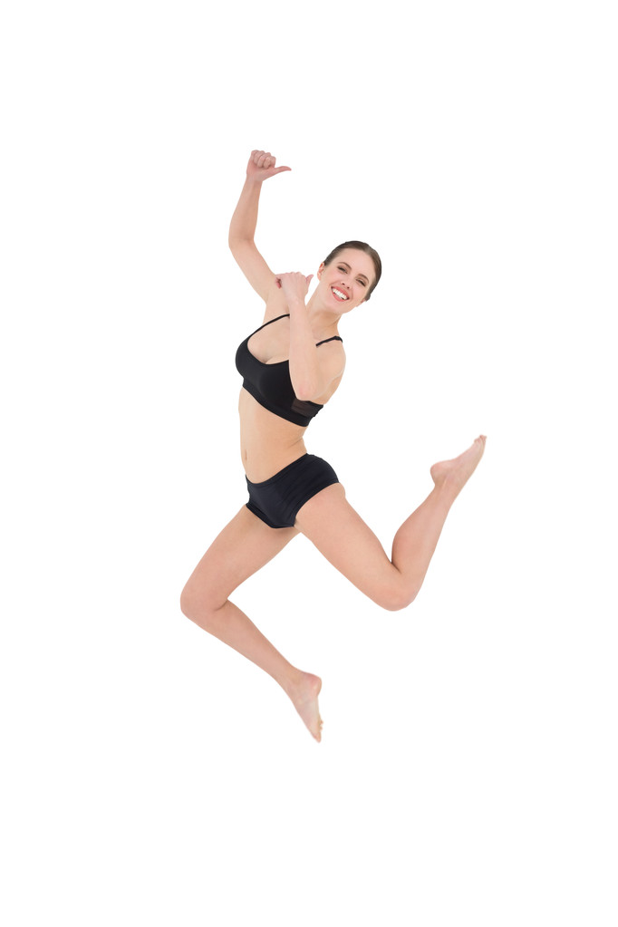sportovní mladá žena skákání izolované na bílém pozadí - Fotografie, Obrázek