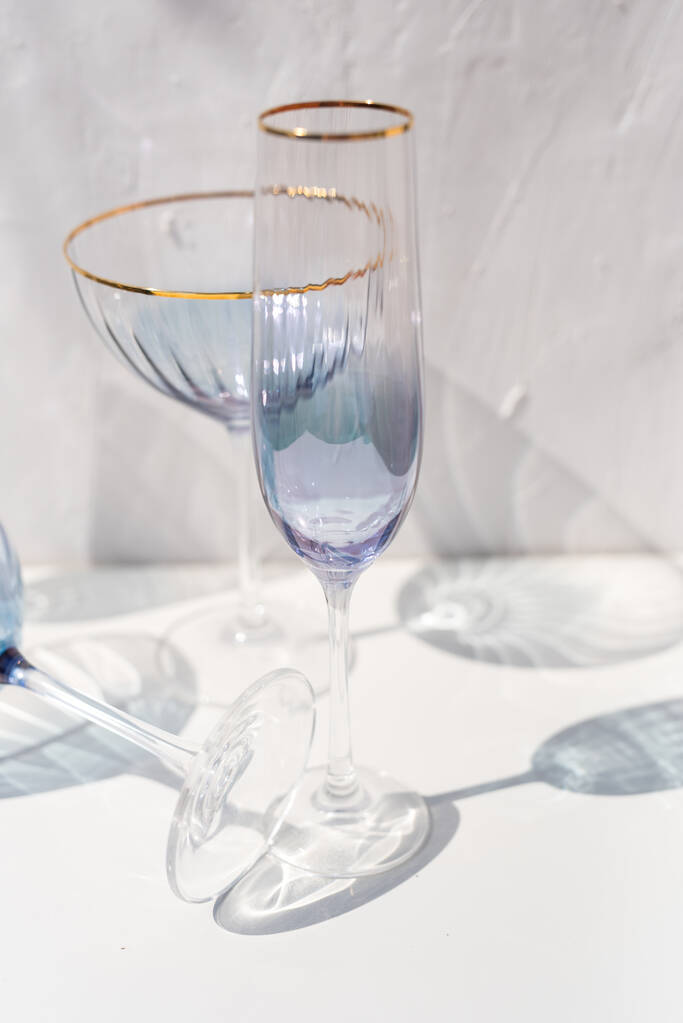 blauw transparant cava glas set met zonlicht reflecties - Foto, afbeelding