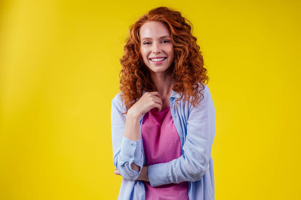 happy redhead ginger curly woman feeling good emotions in studio shot yellow background. language education idea - Photo, Image