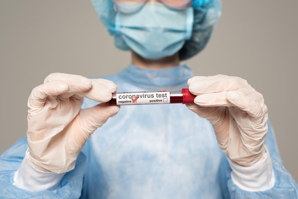 Vista recortada do tubo de ensaio médico com amostra de sangue e letras de coronavírus isoladas em cinzento
 - Foto, Imagem