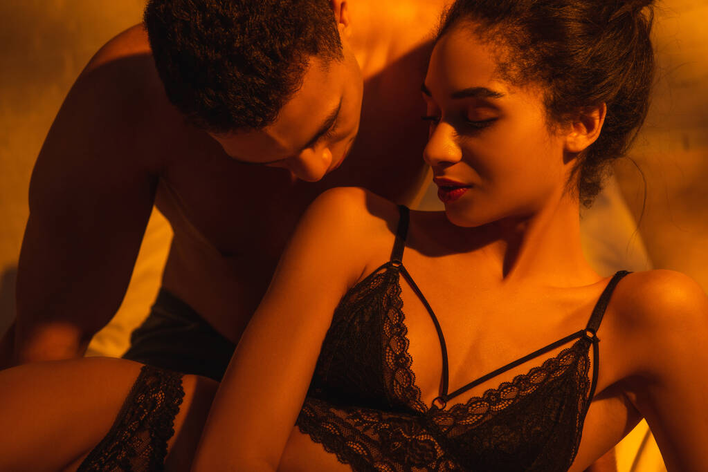 Férfi csók szexi afro-amerikai nő a hálószobában - Fotó, kép