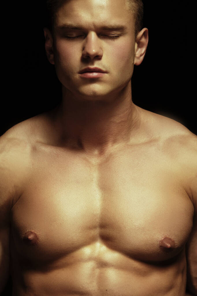 Handsome sport sexy stripped guy portrait on isolated black background - Photo, Image
