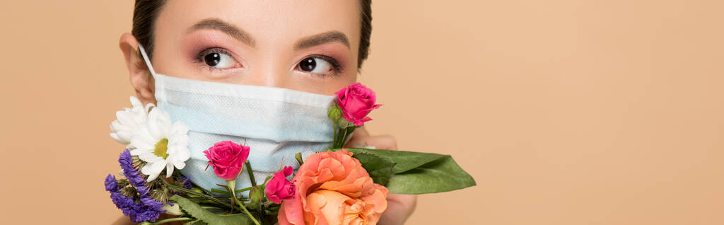 panoramic shot of beautiful asian girl in floral face mask isolated on beige - Photo, Image