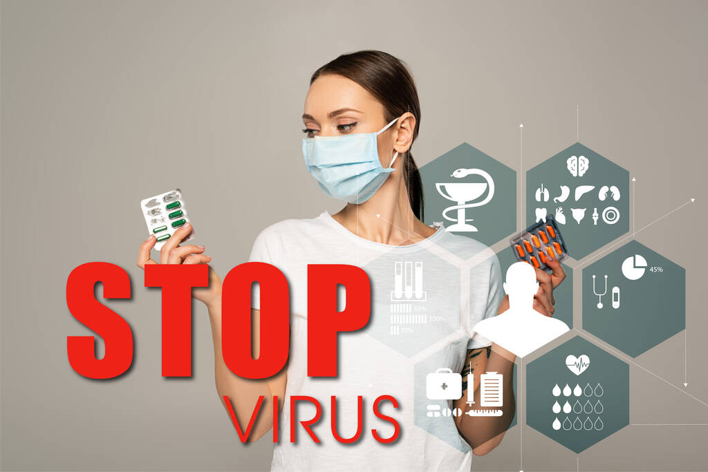 Young woman holding blisters with pills isolated on grey, stop virus lettering and medical signs illustration  - Photo, Image