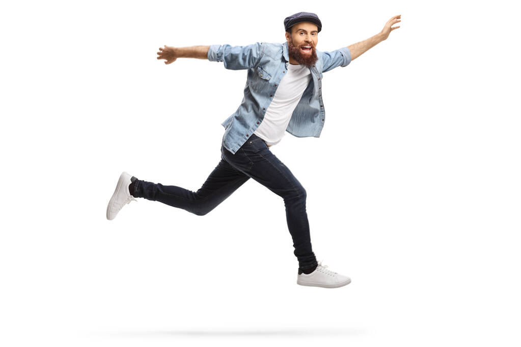 gelukkig baard hipster guy in casual kleding springen geïsoleerd op witte achtergrond - Foto, afbeelding