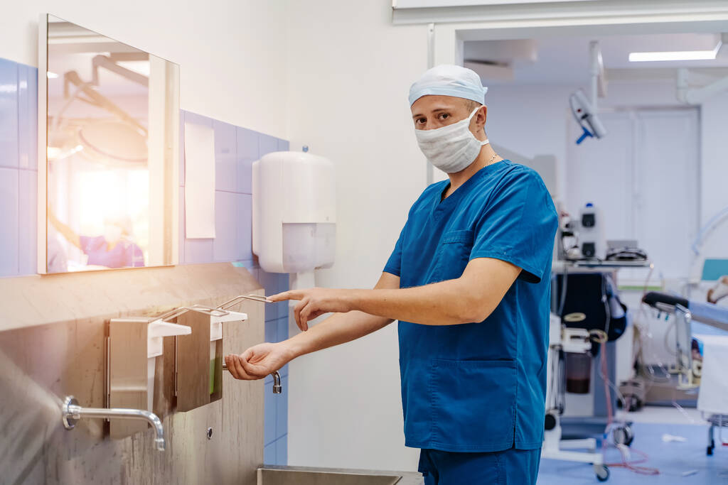 Хірургічна дезінфекція рук. Лікар миє руки, дезінфікує руки перед операцією
. - Фото, зображення