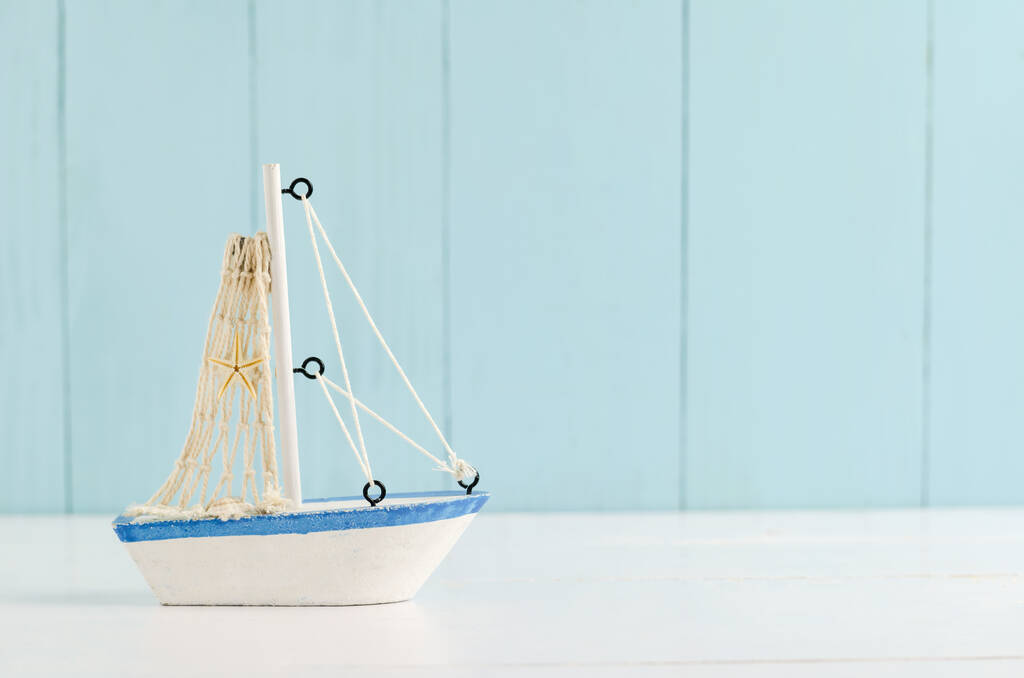 Starožitné plachetnice Toy model s lanem a mušlí na bílém a modrém dřevěném pozadí - Námořní pozadí - Fotografie, Obrázek